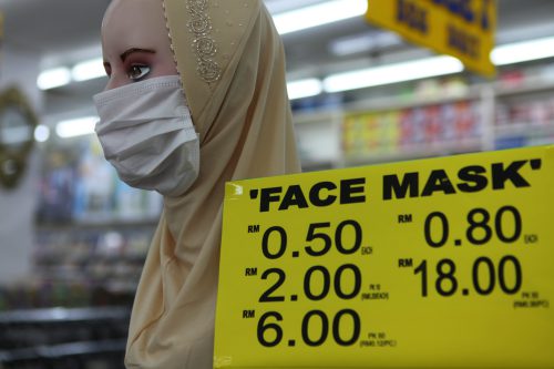 coronavirus mask - A discount market on Penang Island, Malaysia, displays a face mask on a mannequin. Surgical masks are unregulated and provide minimal protection from pathogens.