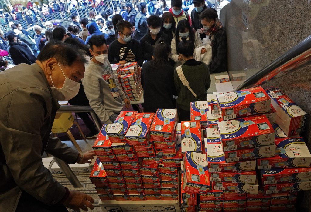 In Hong Kong, people line up to purchase face masks, which have been in short supply in many places across Asia.