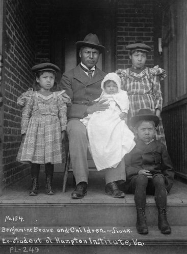 For some families, the transformation to mainstream American society was complete—at least outwardly. Bratley’s photograph of Benjamin Brave’s family shows the transformative effects of Native American boarding school education. Brave attended the Hampton Institute, a school in Virginia for Native Americans and African Americans.