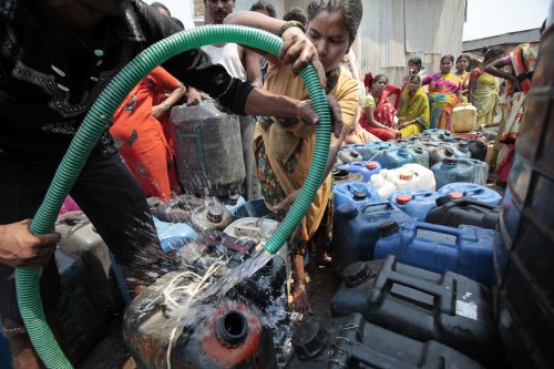 Water scarcity - Residents in Mumbai collect water at a community tank.