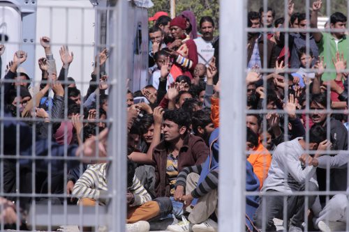 pakistan covid-19 - Migrants from Afghanistan and Pakistan crowd a detention center in Greece in 2016.