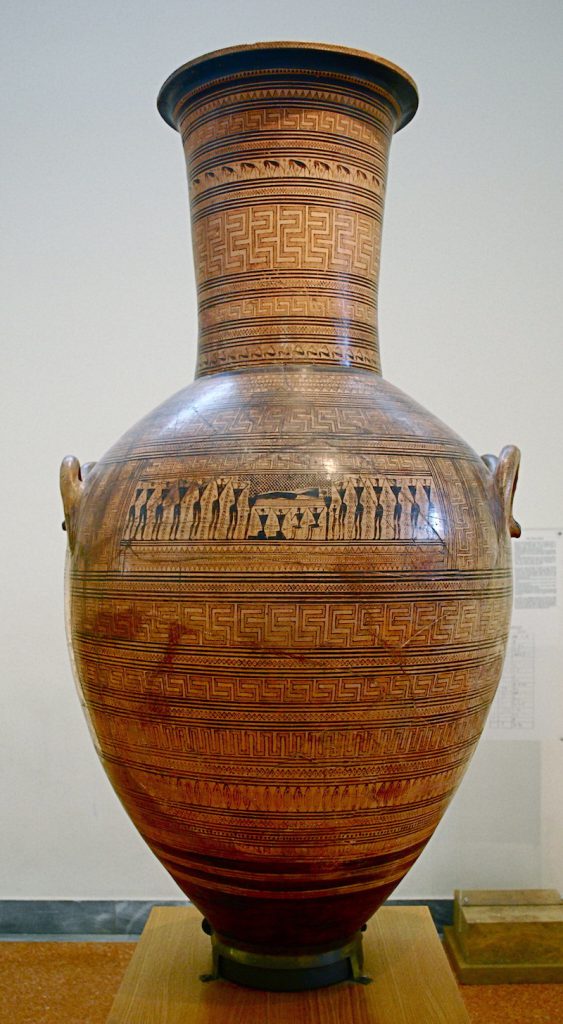 A photo shows a large tan vase with an intricate pattern.