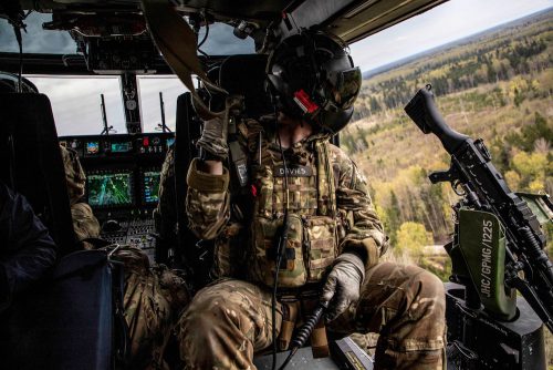 counterterrorism ethnography - A British army helicopter flies over Estonian forests during a massive annual military training exercise.