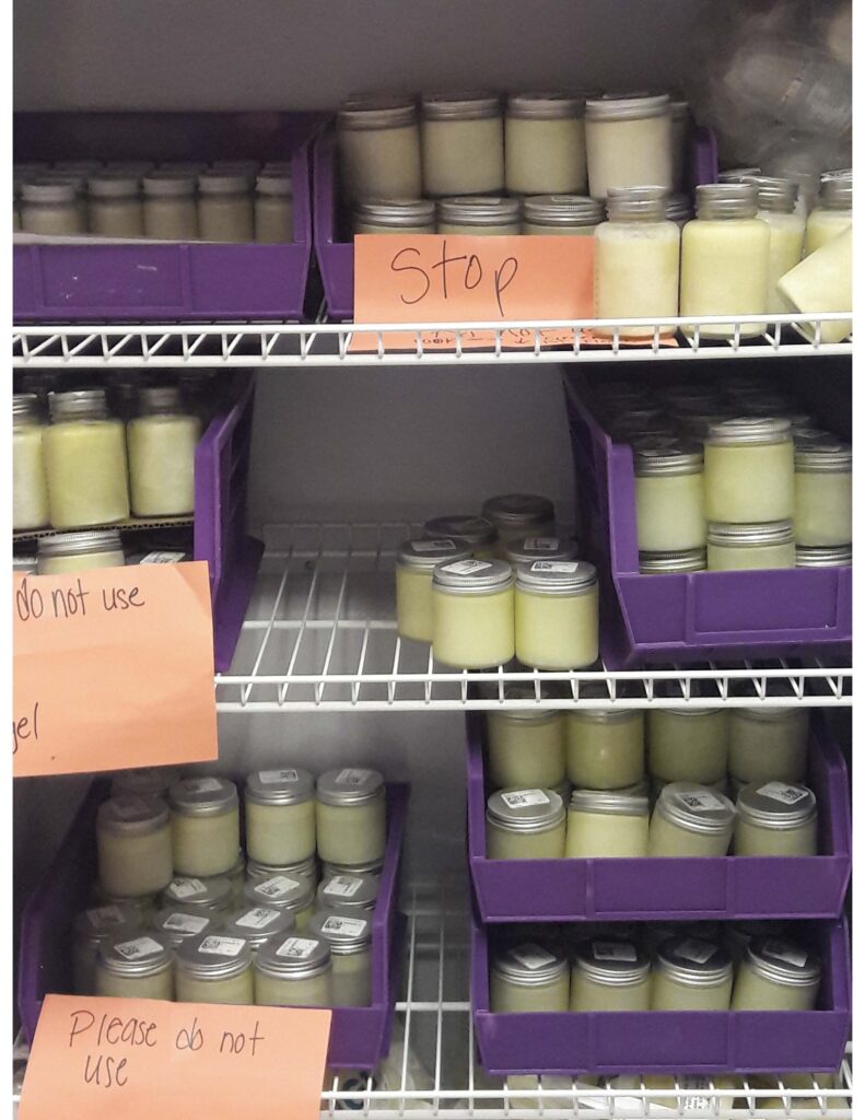 A photo shows small jars of white liquid sitting on refrigerator racks.