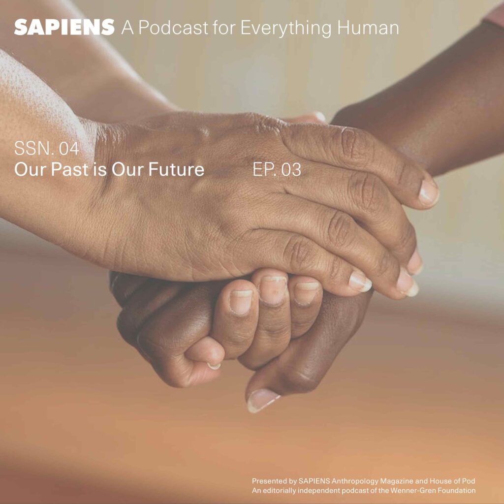 Two people who dark skin hold each others' hands.