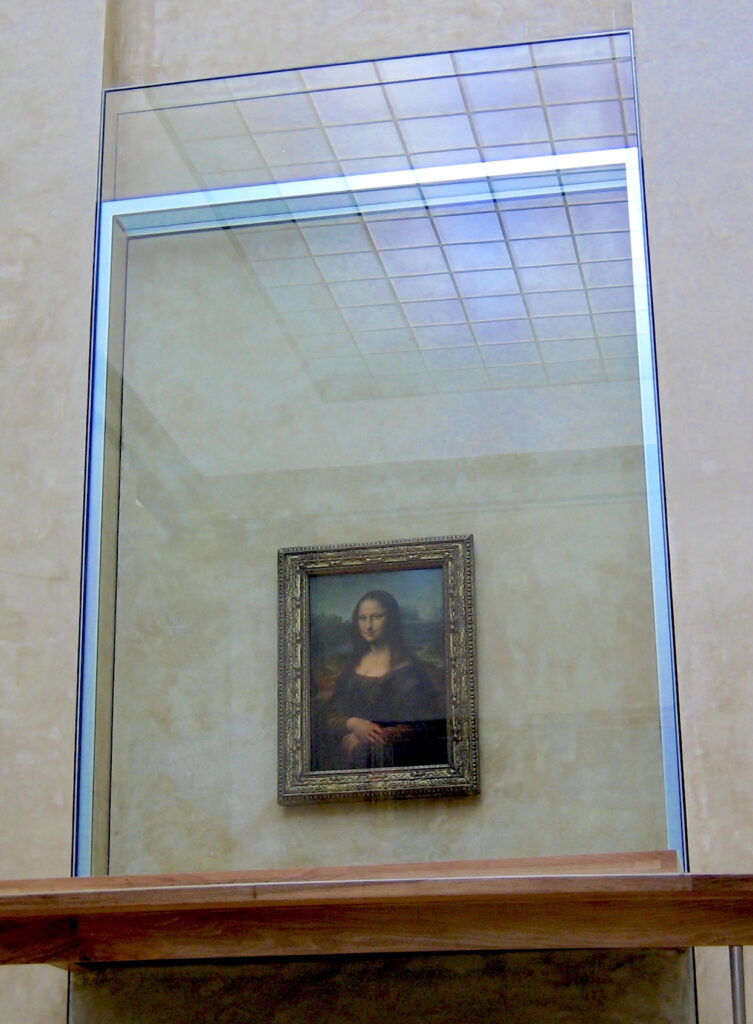 A framed painting of a woman hangs on a wall behind a large pane of glass.