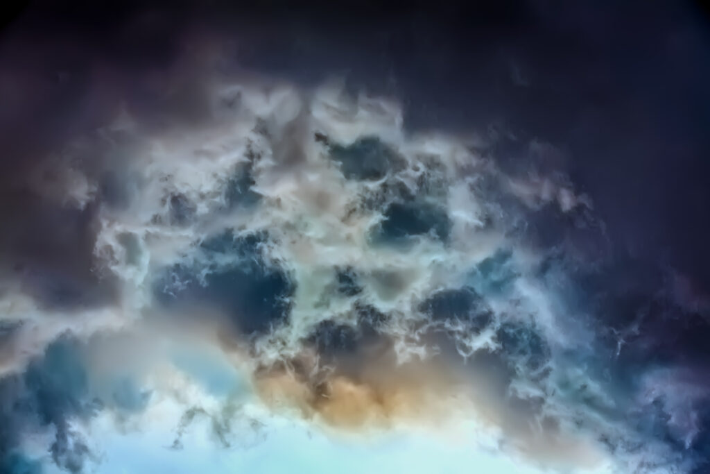 Gray and yellow clouds fill a dark blue sky.