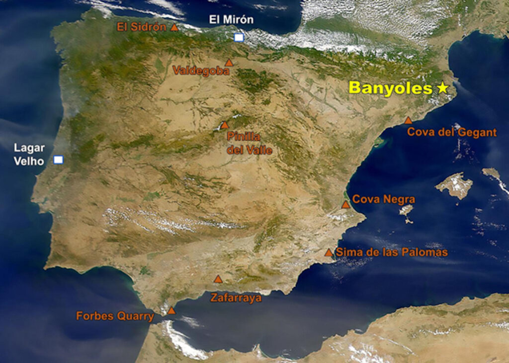 A graphic depicts a map of a green-and-tan shaded landmass largely surrounded by blue. The word “Banyoles” in yellow text next to a yellow star is in the upper right-hand section of the landmass. Other locations are indicated, scattered about in orange text next to orange triangles and in white text next to white squares.