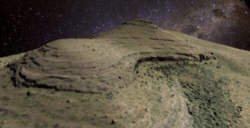 A computer-rendered graphic shows a rocky hill with sparse greenery at its base against a dark blue, starry sky.
