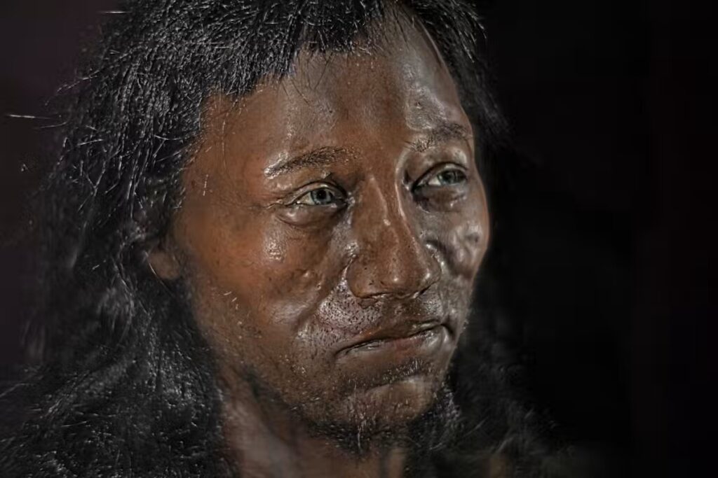 The head of a manikin features a human face with blue eyes and dark, textured skin.